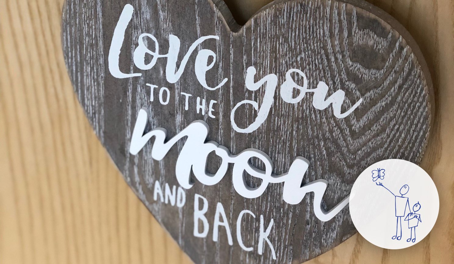 Wooden heart sign with words "Love you to the moon and back"