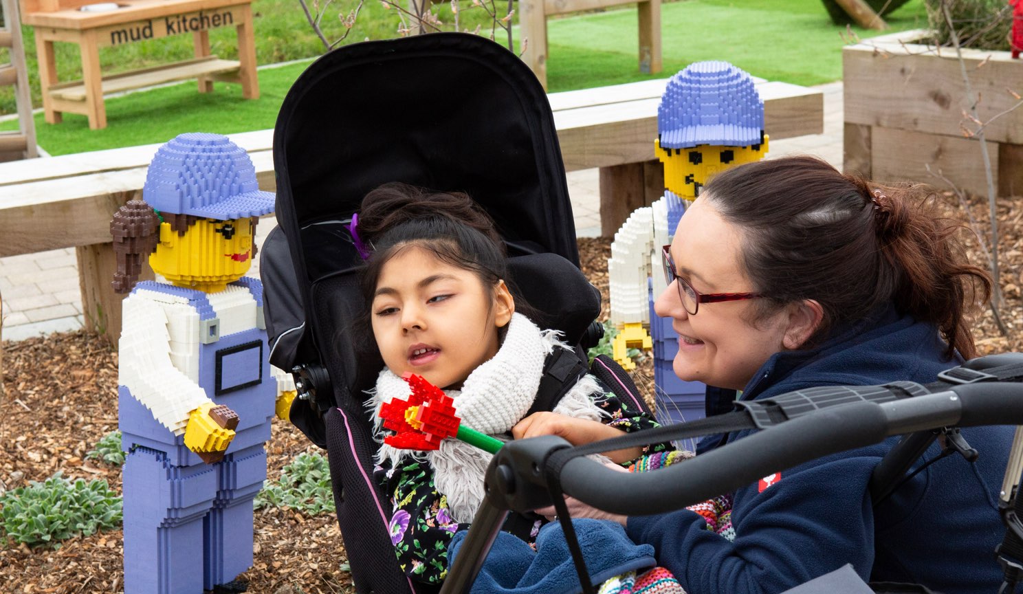 Alexander Devine Children in Gardens with Lego figures.