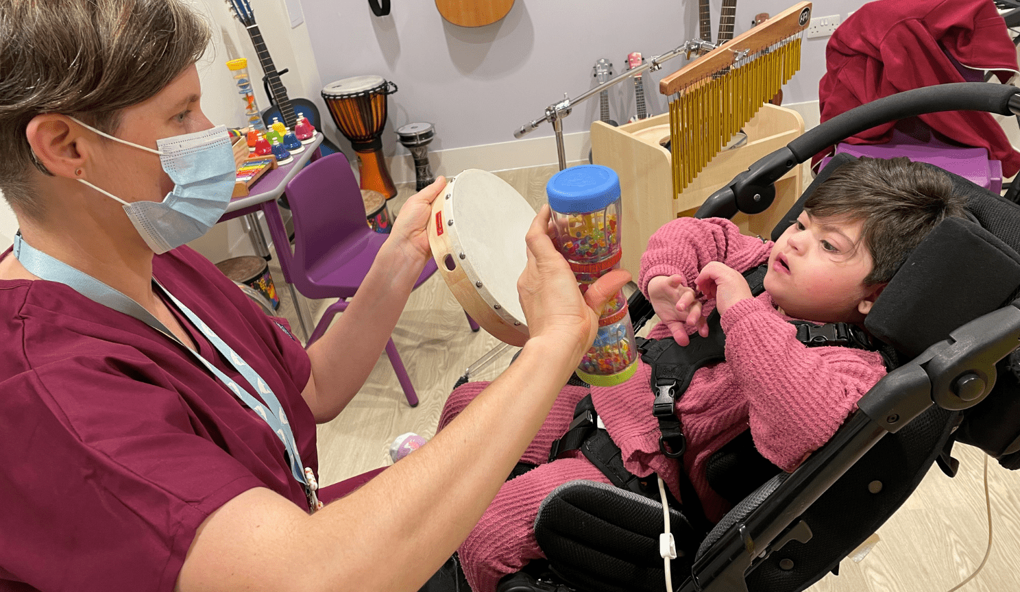 Young girl playing with a xylophone.