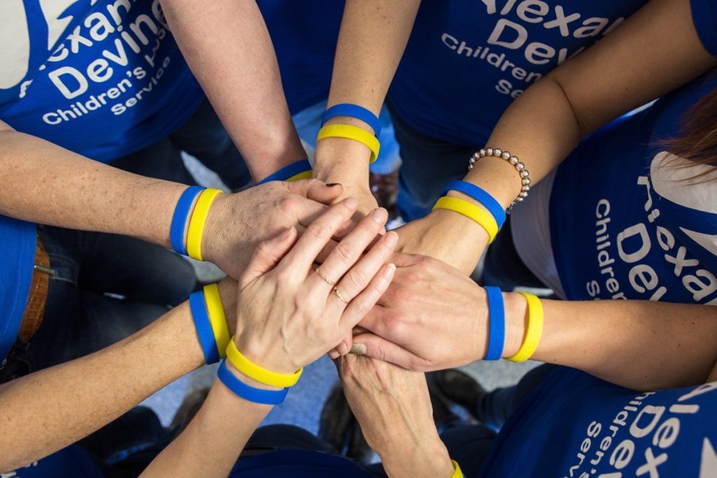 Alexander Devine team, hands in.